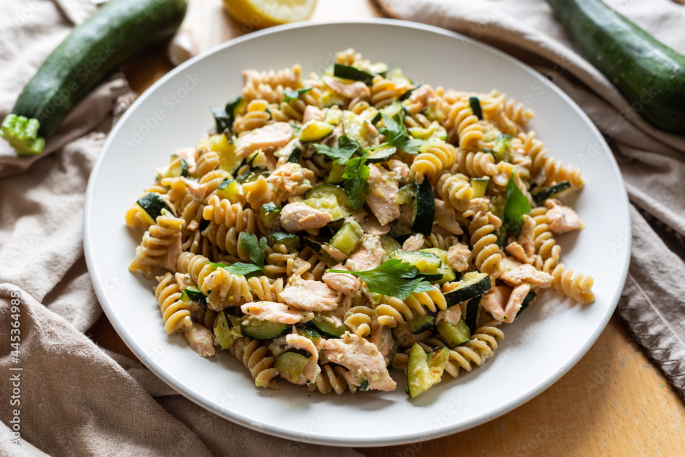 Fusilli pasta with zucchini and salmon fish.