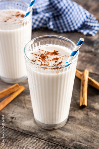 Fresh horchata with cinnamon in glass on rustic wooden table