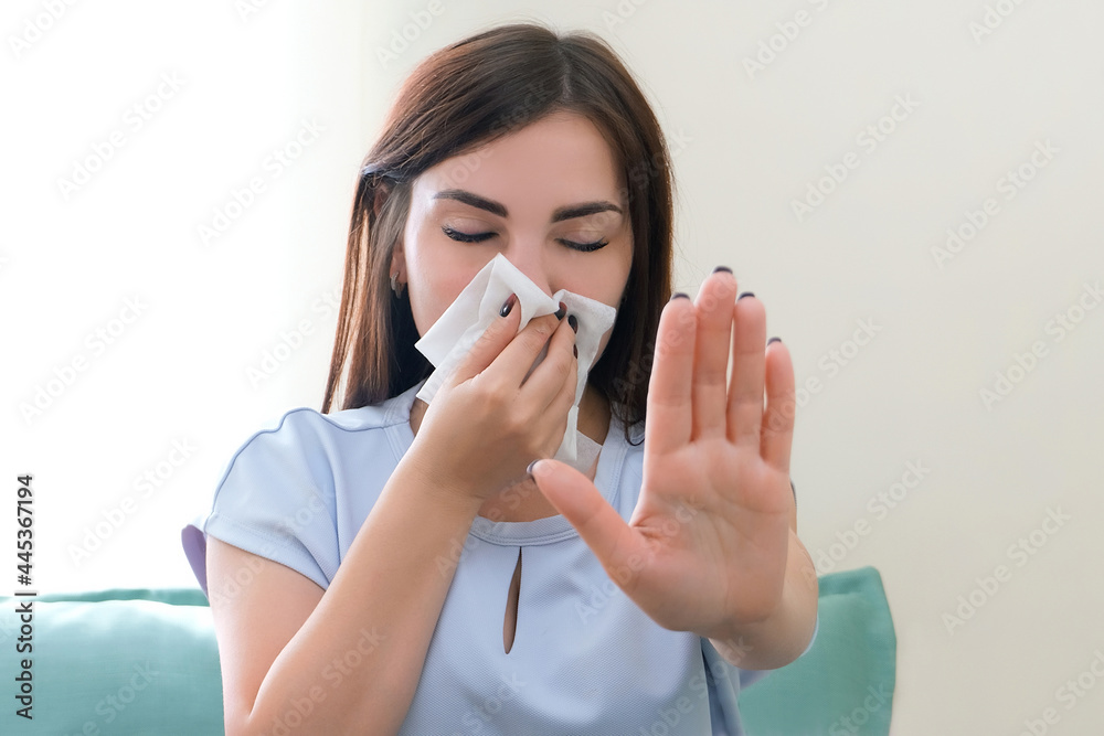 allergy in a young woman. Young woman with a scarf on her nose. allergy in a young woman. Young woman with a scarf on her nose.