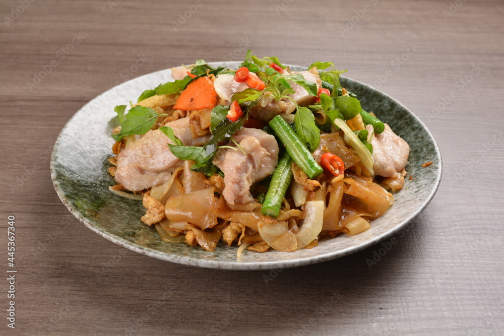 wok fried noodle phad Thai with chicken meat on wood background asian halal set lunch menu wok fried noodle phad Thai with chicken meat on wood background asian halal set lunch menu
