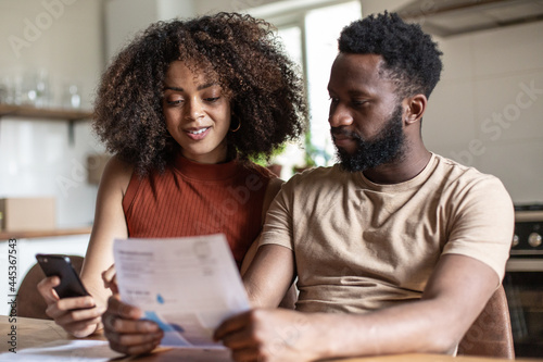 African american couple paying bills together