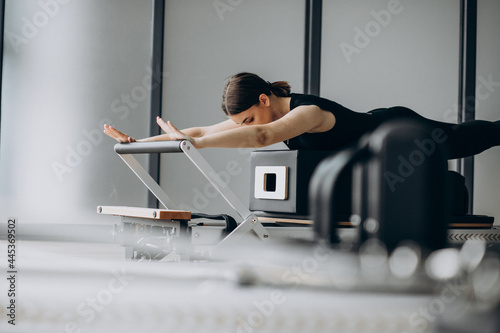 Woman training pilates on the reformer photo