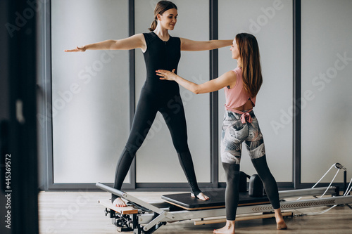 Woman training pilates on the reformer photo