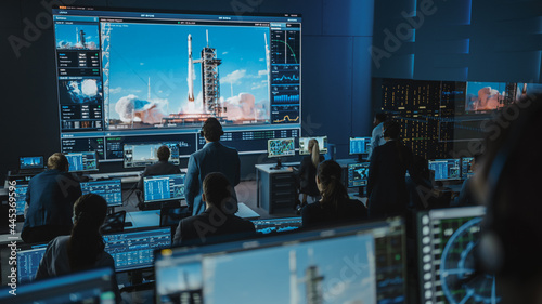 Foto Group of People in Mission Control Center Witness Successful Space Rocket Launch