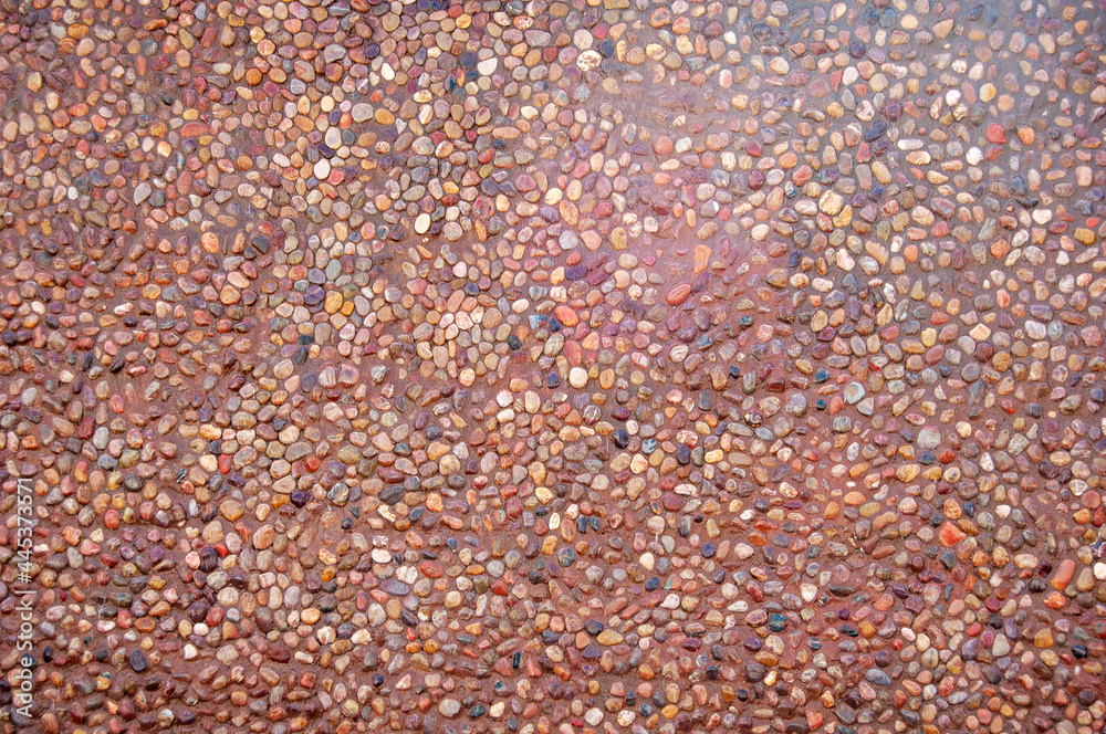 Transparent water flows down the pebbles. Pebble or gravel background or texture. Transparent water flows down the pebbles. Pebble or gravel background or texture.