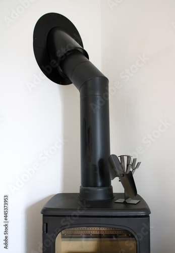 New black stove with pipe isolated on white