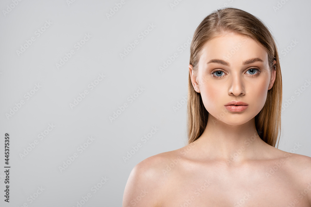 young woman with bare shoulders and blue eyes isolated on grey young woman with bare shoulders and blue eyes isolated on grey