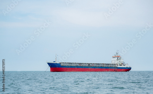 Large cargo ship in the ocean with blue sky landscape,Cargo shipping boat concept in the sea logistic economy