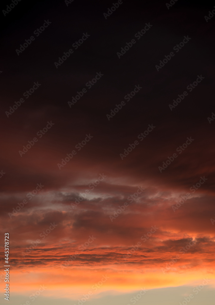 Evening sky in red and black as a background portrait format
