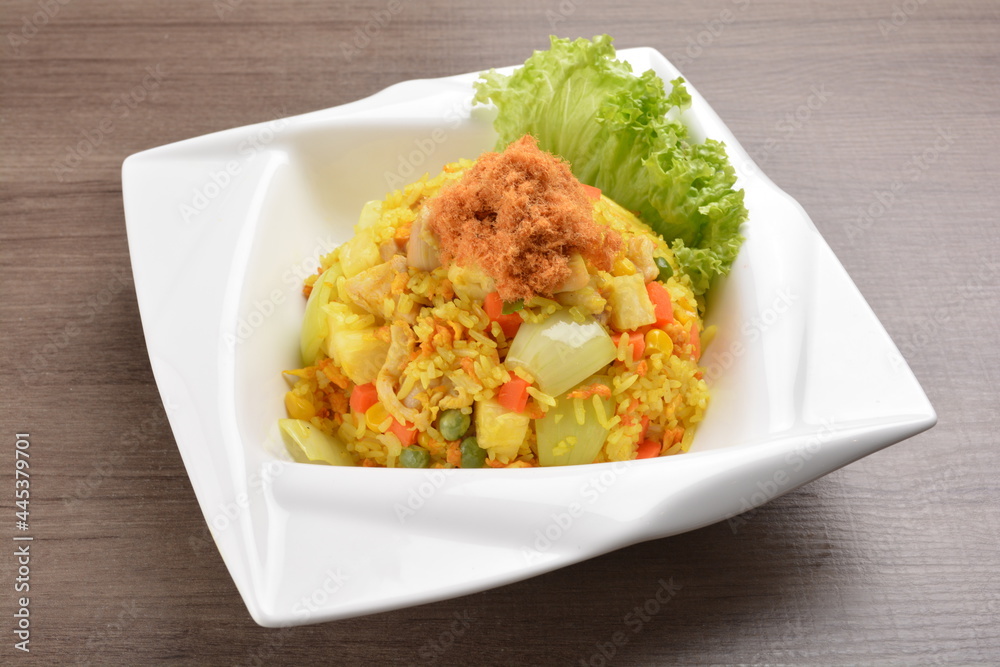 Thai golden pineapple wok fried rice with chicken floss on wood table asian halal menu Thai golden pineapple wok fried rice with chicken floss on wood table asian halal menu