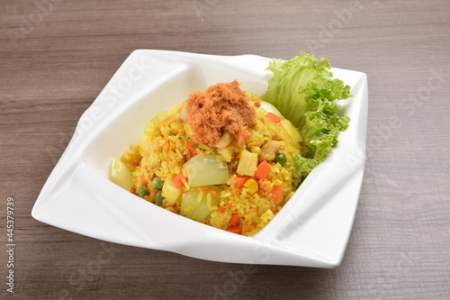 Thai golden pineapple wok fried rice with chicken floss on wood table asian halal menu
