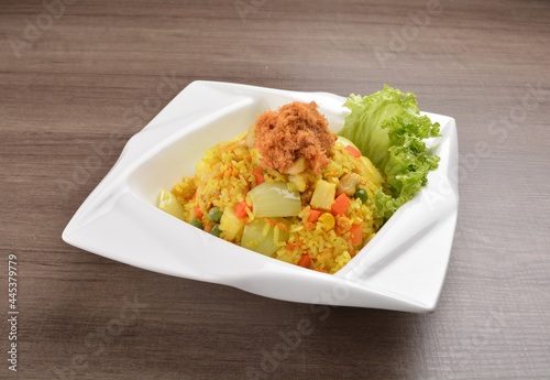 Thai golden pineapple wok fried rice with chicken floss on wood table asian halal menu