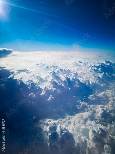Aerial view from plane to morning sunrise over clouds