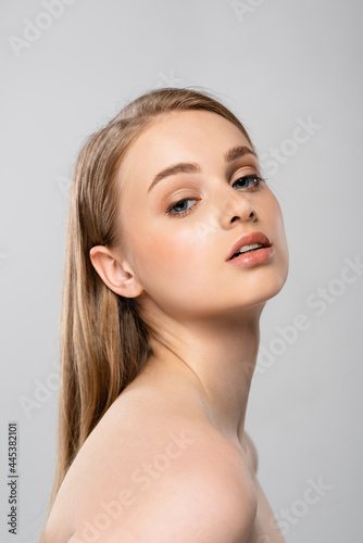 young woman with bare shoulders isolated on grey
