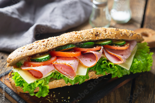 Large sandwich with ham, cheese and vegetables