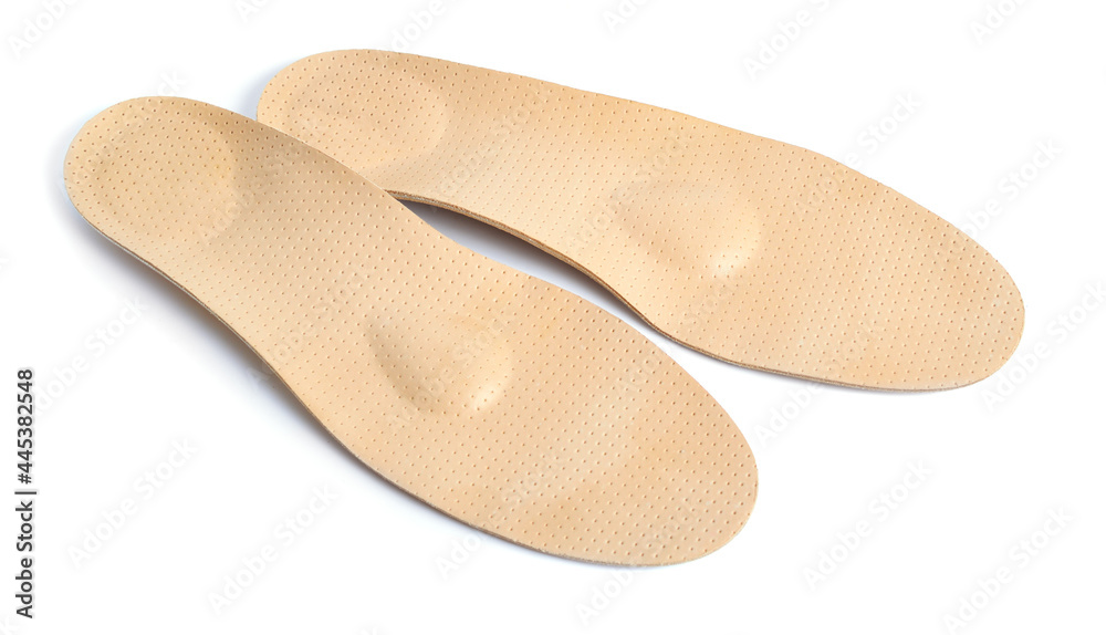 A pair of orthopedic insoles. Isolated on white background A pair of orthopedic insoles. Isolated on white background