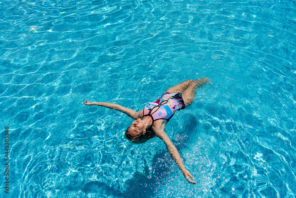 Young woman lies on a water surface in the crystal pool
