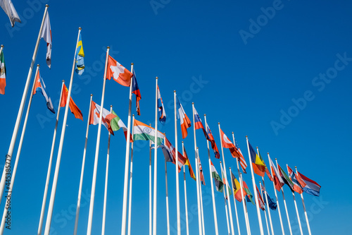 Different flags fluttering on flagpoles