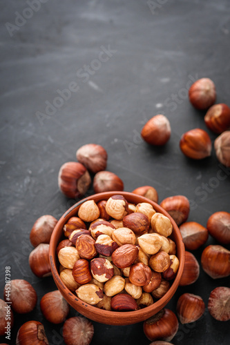 fresh natural hazelnuts on a dark stone background