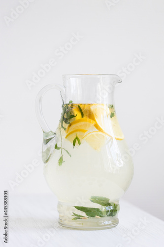 Pitcher of lemonade on the white table.