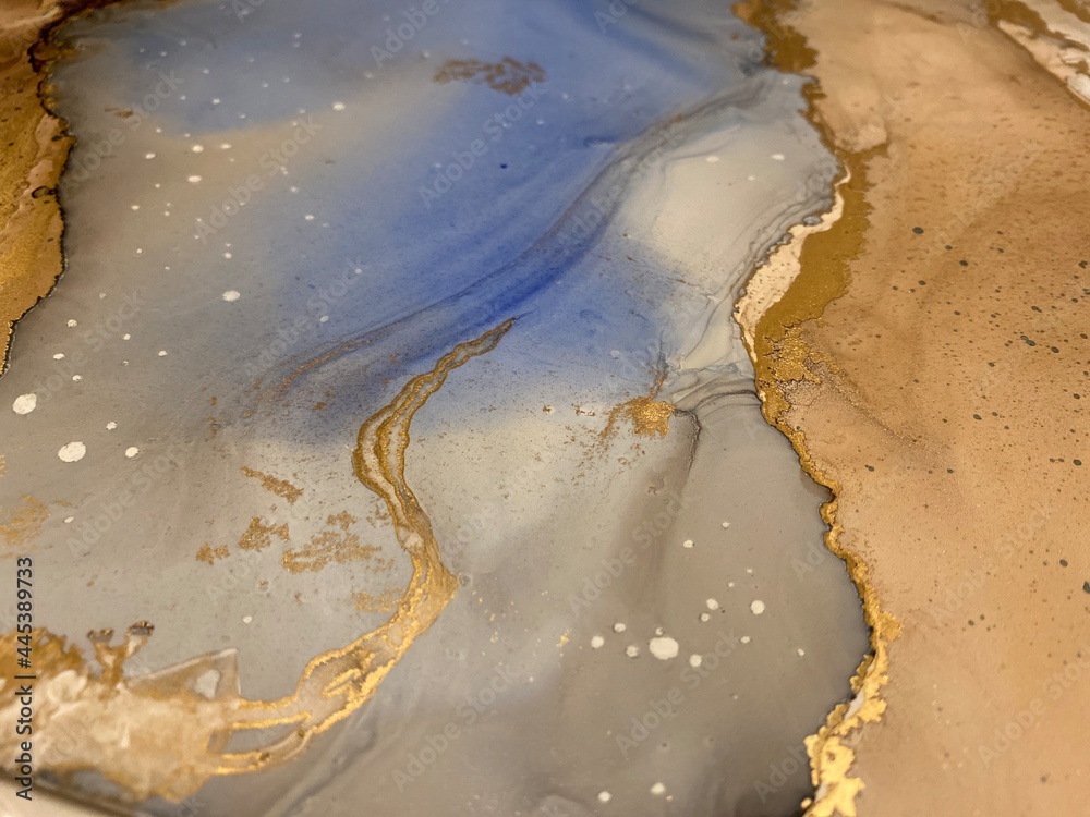 Abstract brown art with blue and gold — beige background, beautiful smudges and stains made with alcohol ink and golden paint. Blue fluid texture resembles tree bark, landscape, watercolor, aquarelle.