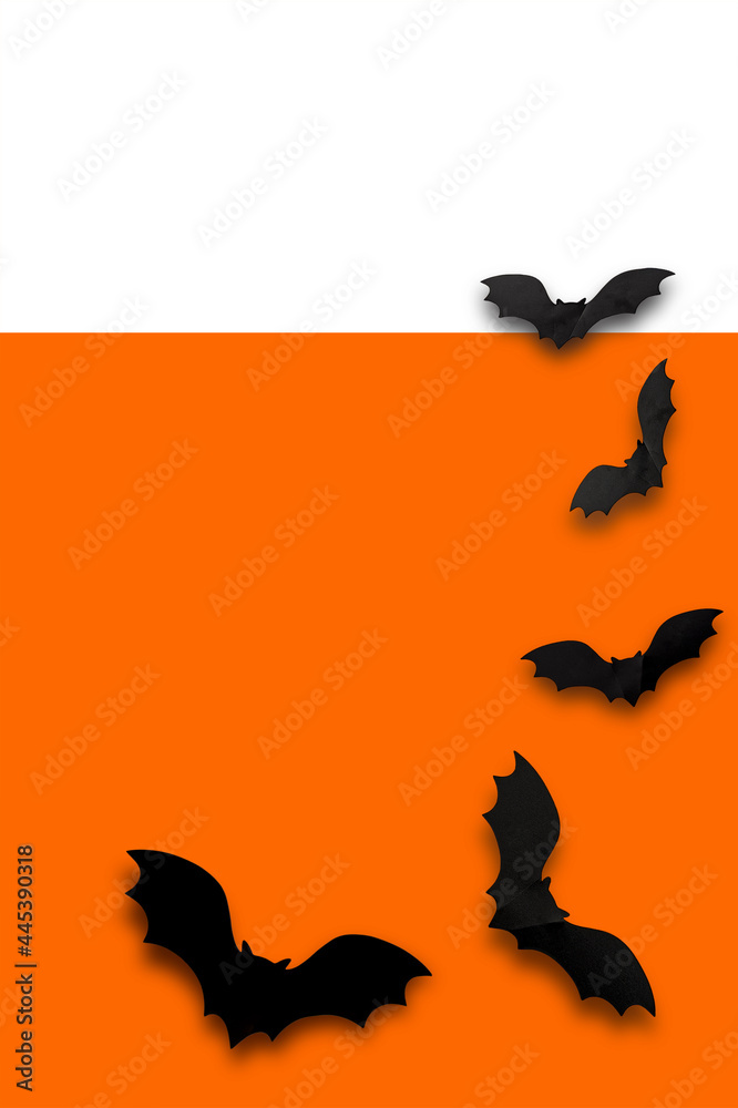 Black Halloween. Black bats on an orange white background. Vertical photo, an empty space for text or image