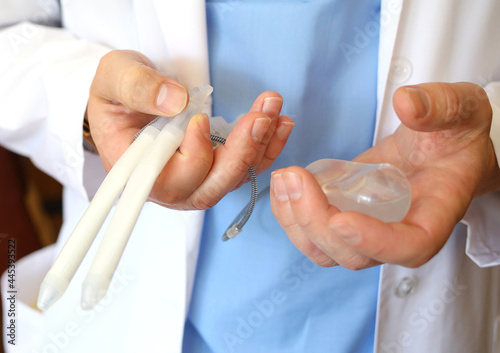 Doctor andrologist holding hydraulic penile prosthesis for falloprosthetics. Penile prosthesis. Urology and Andrology. Health male concept