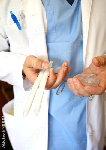 Doctor andrologist holding hydraulic penile prosthesis for falloprosthetics. Penile prosthesis. Urology and Andrology. Health male concept