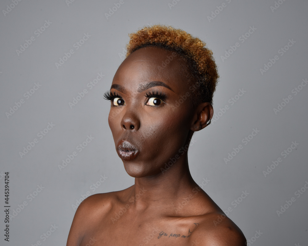 Close up head and shoulders portrait of a pretty young African woman with natural hair. variety of emotive facial expressions. Isolated on a light grey studio background. Close up head and shoulders portrait of a pretty young African woman with natural hair. variety of emotive facial expressions. Isolated on a light grey studio background.