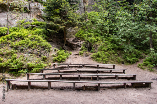 Empty benches of a natural theater in the woods