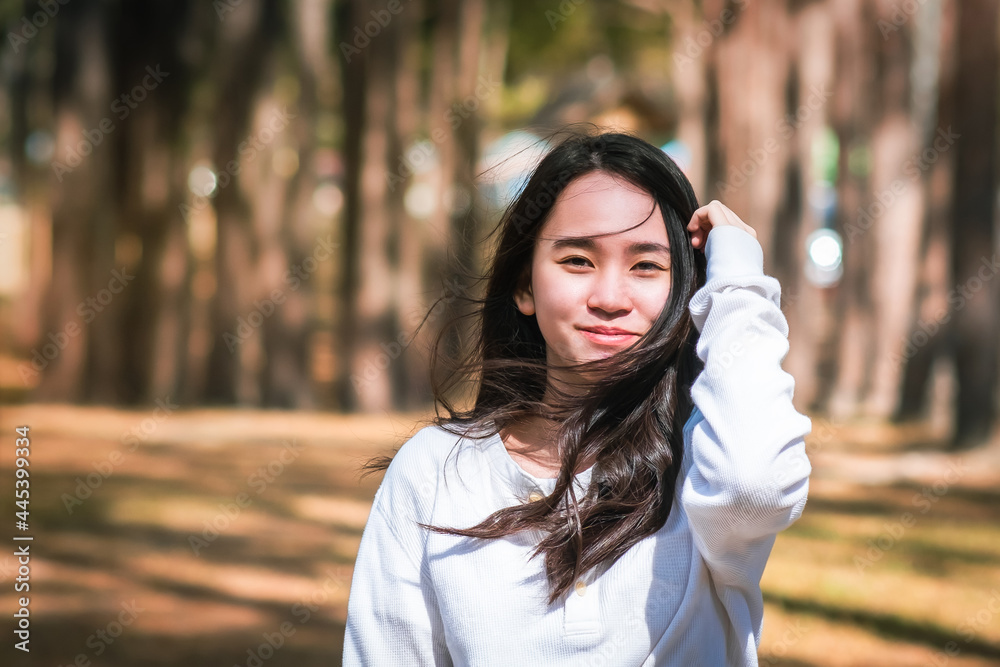 Portrait of  a beautiful teenager girl with long hair in the Park,