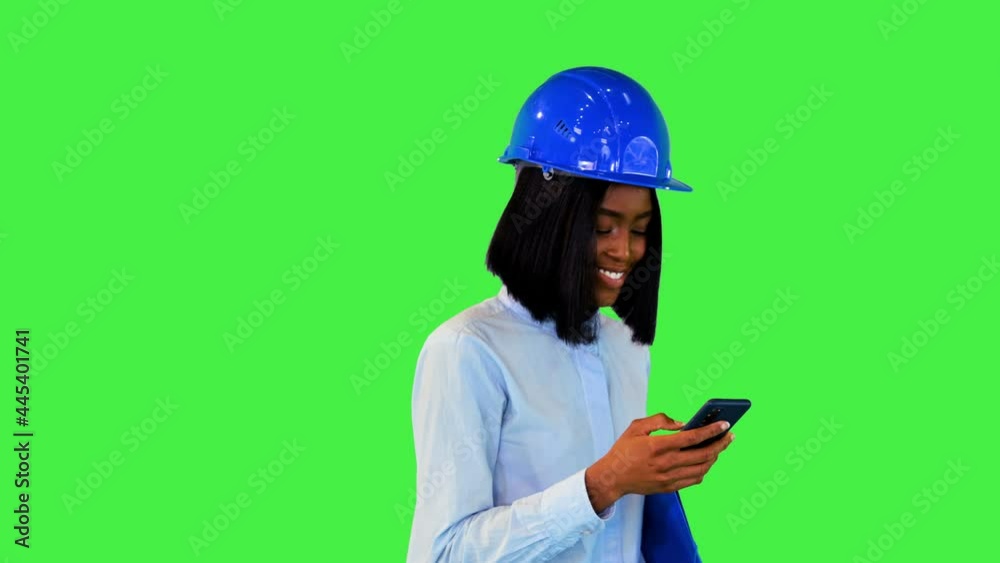 African architect construction project developer walk read messages in mobile nodding in approval on a Green Screen, Chroma Key. African architect construction project developer walk read messages in mobile nodding in approval on a Green Screen, Chroma Key.