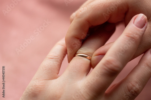 girl takes off gold wedding ring close-up
