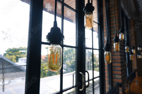 Decorative lights in the cafe with a window background. modern cafe interior