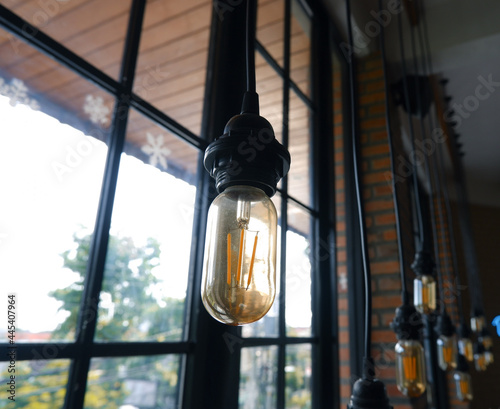 Decorative lights in the cafe with a window background. modern cafe interior photo