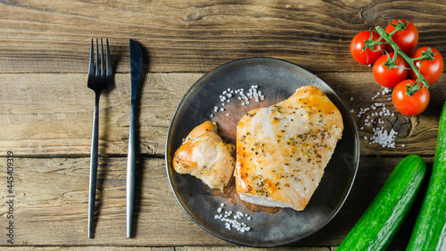 Baked turkey in the oven on the wooden background