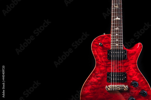 Red glossy electric guitar in dark environment