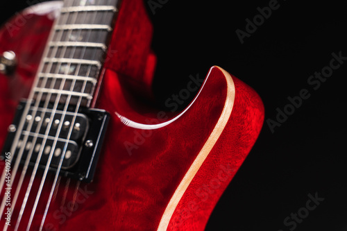 Red glossy electric guitar closeup showing binding of wooden body
