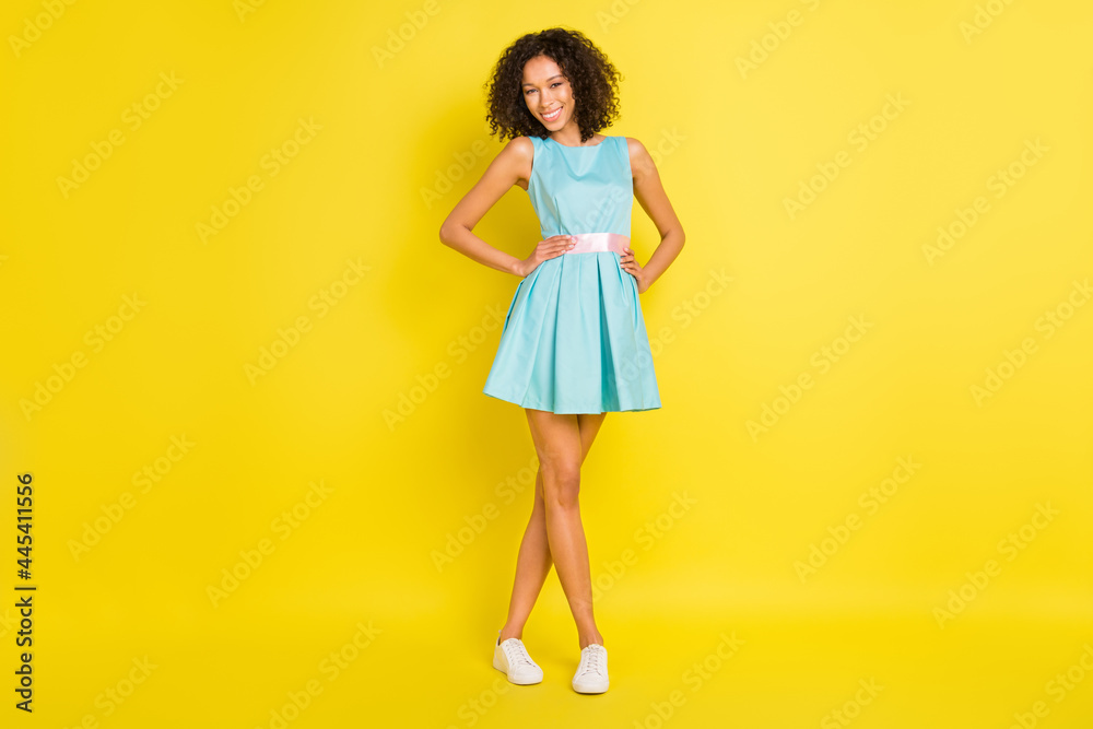 Full length photo of cool wavy hairdo millennial lady wear blue dress sneakers isolated on yellow color background