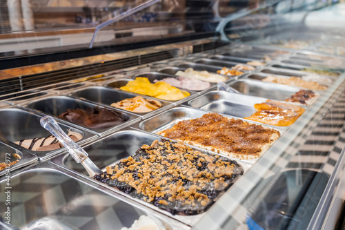 Different flavors of ice cream displayed at store photo