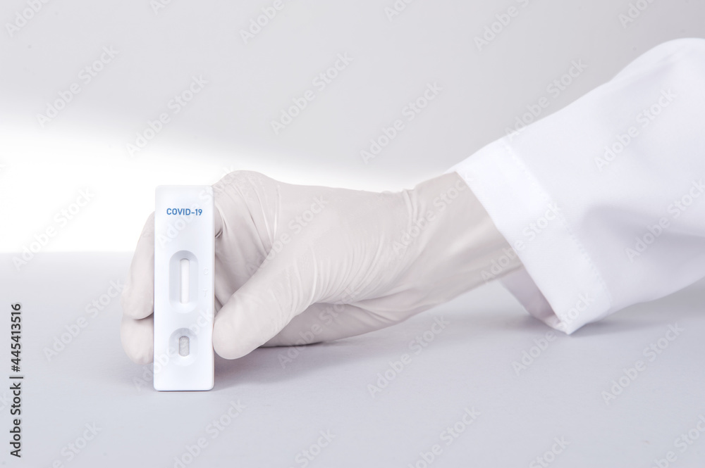 Doctor or scientist hand with white glove holding a test kit for viral disease COVID-19 2019-nCoV or Lab card kit test for coronavirus SARS-CoV-2 virus Doctor or scientist hand with white glove holding a test kit for viral disease COVID-19 2019-nCoV or Lab card kit test for coronavirus SARS-CoV-2 virus