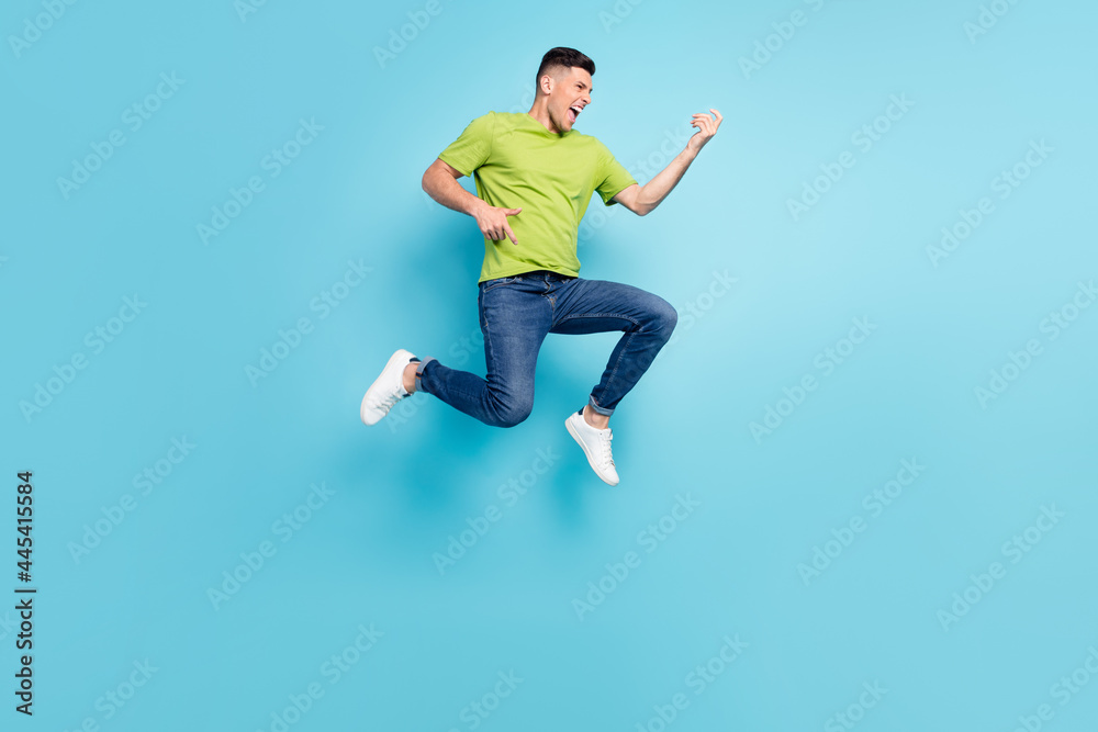 Full length body size photo man jumping up imagine playing guitar isolated pastel blue color background