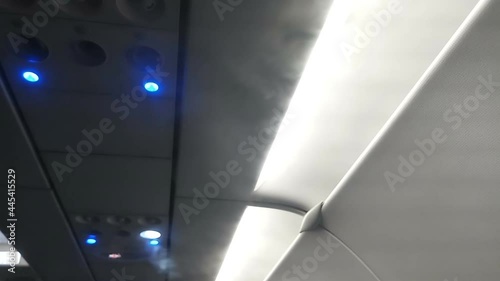 Air conditioing outlets of an aeroplane are releasing cool air to keep temparature down inside flight. photo