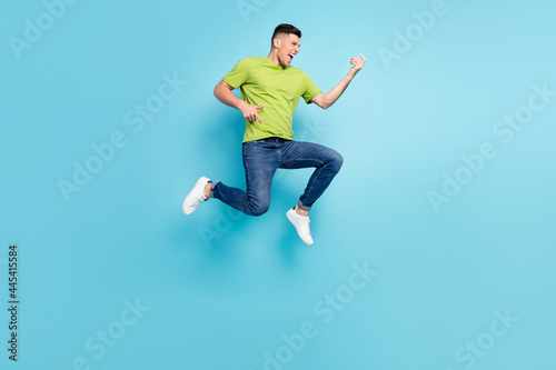 Full length body size photo man jumping up imagine playing guitar isolated pastel blue color background