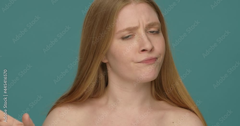 Naked young woman with long blond hair shaking head and hands in a gesture of denial Naked young woman with long blond hair shaking head and hands in a gesture of denial