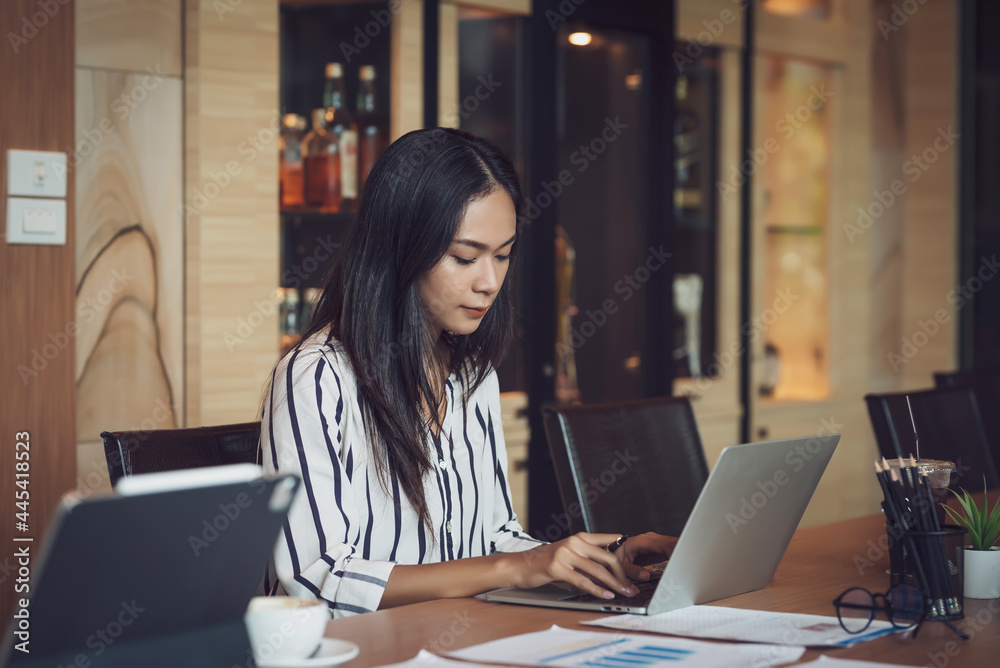 Image of a young Asian business woman sitting in a meeting at the office. Image of a young Asian business woman sitting in a meeting at the office.