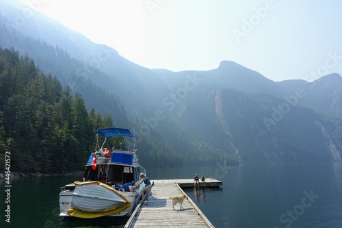 An incredible view of princess louisa inlet from the dock with one family and their boat tied up, in British Columbia, Canada.