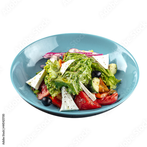 Isolated plate of greek salad with fresh vegetables on white