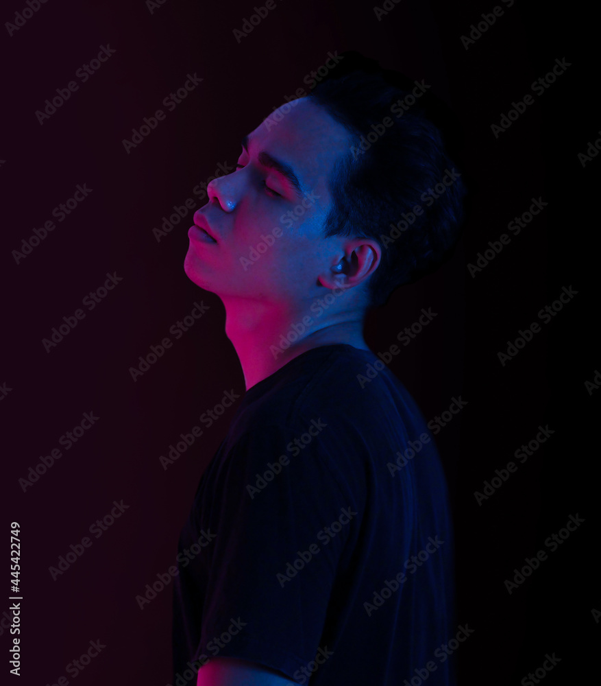 Portrait of a young man neon light side view. Portrait of a young man neon light side view.