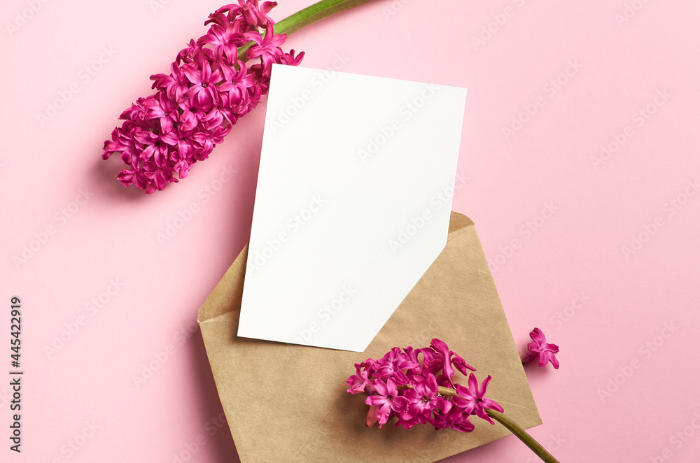 Greeting or invitation card mockup with envelope and hyacinth flowers on pink paper background Greeting or invitation card mockup with envelope and hyacinth flowers on pink paper background